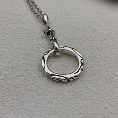 the silver chain is paired with a cross