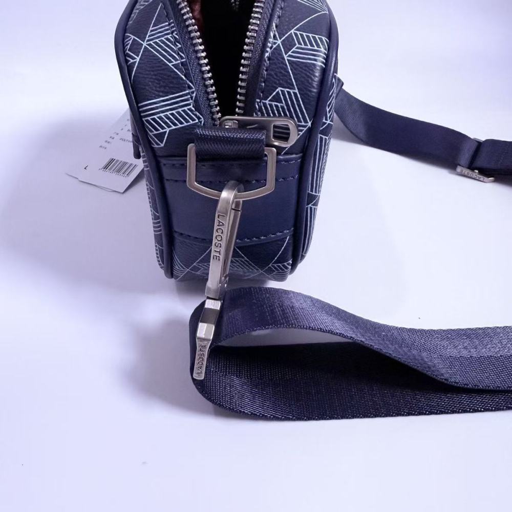 LACOSTE Textured geometric print crossbody bag for a high-end fashion look.