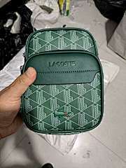 Bags from the LACOSTE (French Crocodile) brand, a well-known French fashion brand known for its iconic crocodile logo and classic design. These two bags have unique geometric patterns, and the colour scheme is white on a green background and white on a bl