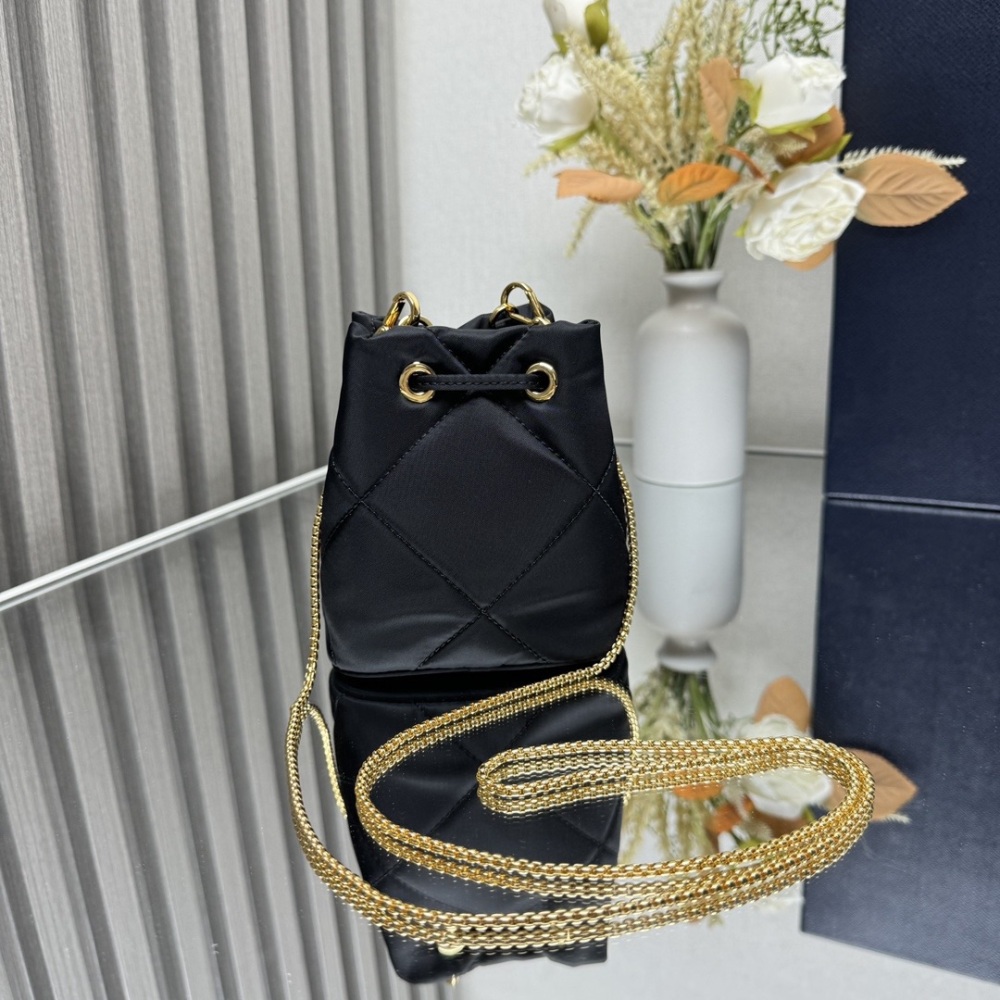 Embroidered grid small water bucket adopts complex embroidered grid handmade and nylon fabric, decorated with enamel metal triangular logo for opening and closing design