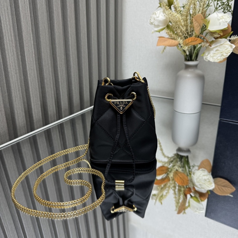 Embroidered grid small water bucket adopts complex embroidered grid handmade and nylon fabric, decorated with enamel metal triangular logo for opening and closing design