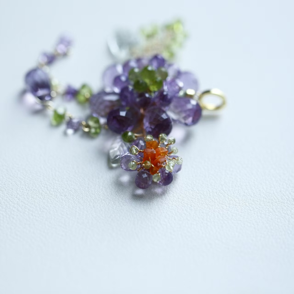 Hand-woven amethyst paired with peridot fire opal flower pendant