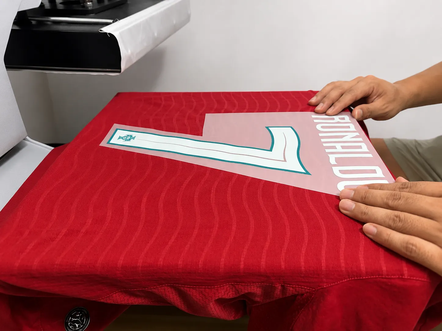 Player name and number being aligned on the back of a football jersey