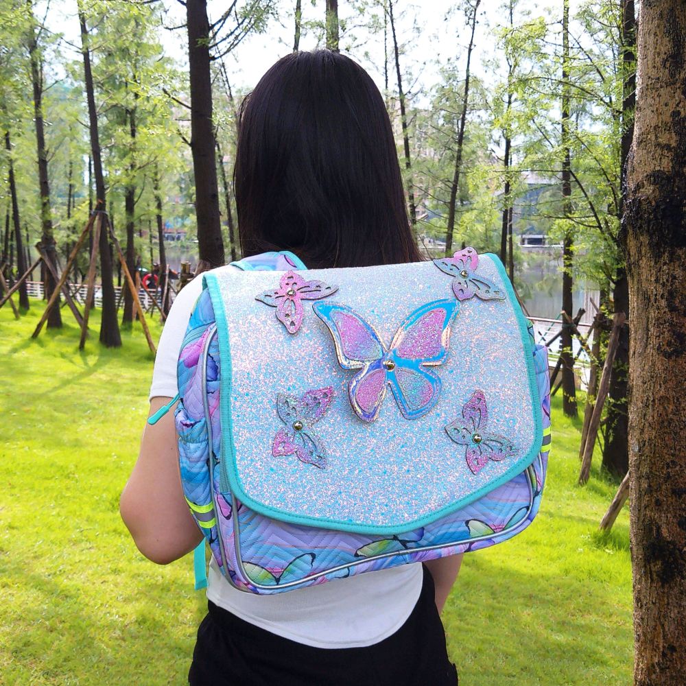 Butterfly decorations, flip-top covers, and student schoolbags