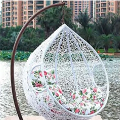 Elegant White Wicker Outdoor Swing Chair with Vibrant Floral Cushion for Garden Tranquility,Stylish Black Rattan Outdoor Swing Chair with Vibrant Floral Cushions for Garden Relaxation