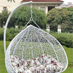 Graceful White Rattan Outdoor Swing Chair with Delicate Floral Cushion for Backyard Retreat,Stylish Black Rattan Outdoor Swing Chair with Vibrant Floral Cushions for Garden Relaxation