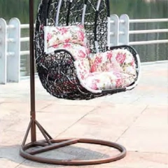 Elegant Dark Rattan Swing Chair with Floral Cushion for Outdoor Tranquility,Rustic Brown Rattan Swing Chair with Sunflower-Inspired Cushion for Garden Comfort