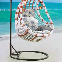 Exotic White and Brown Rattan Swing Chair with Floral Accents for Coastal Relaxation,Exotic White and Brown Rattan Swing Chair with Floral Accents for Coastal Relaxation