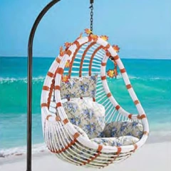 Exotic White and Brown Rattan Swing Chair with Floral Accents for Coastal Relaxation,Exotic White and Brown Rattan Swing Chair with Floral Accents for Coastal Relaxation