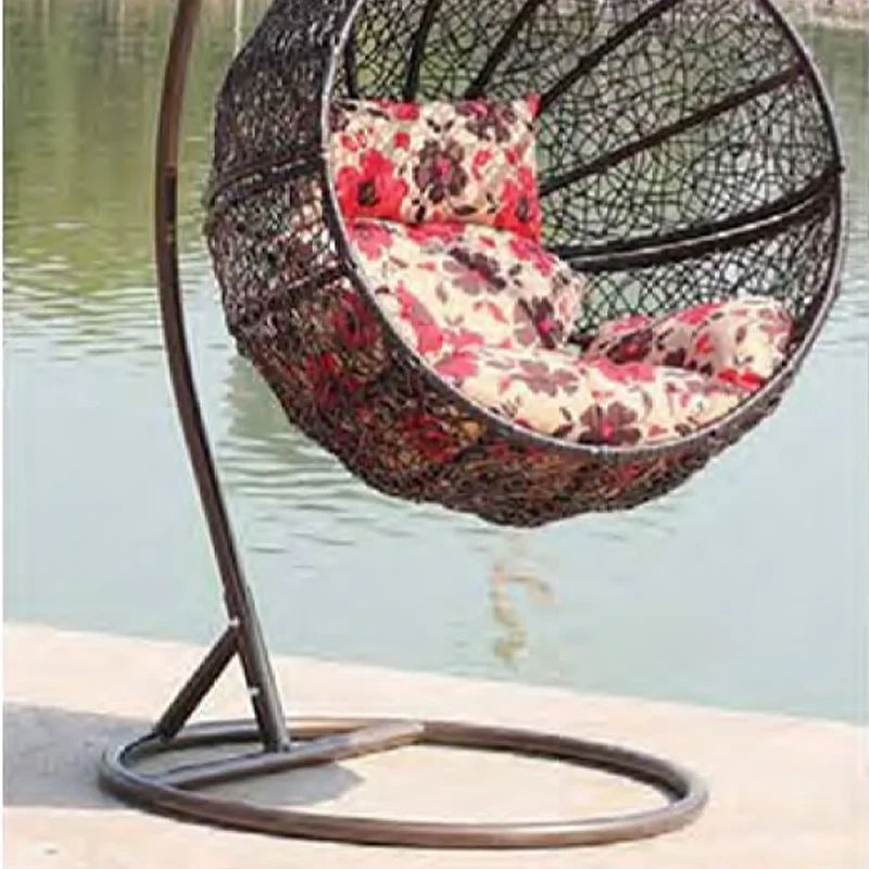 Charming Dark Rattan Swing Chair with Floral Patterned Cushion for Lakeside Relaxation,Romantic White Rattan Swing Chair with Heart-Shaped Red Cushion for Beachside Serenity