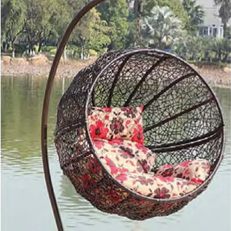 Charming Dark Rattan Swing Chair with Floral Patterned Cushion for Lakeside Relaxation,Romantic White Rattan Swing Chair with Heart-Shaped Red Cushion for Beachside Serenity