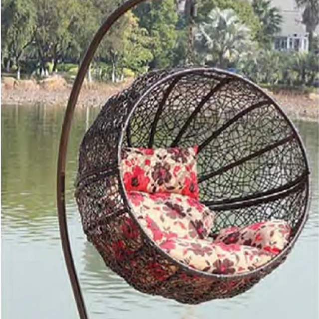 Charming Dark Rattan Swing Chair with Floral Patterned Cushion for Lakeside Relaxation,Romantic White Rattan Swing Chair with Heart-Shaped Red Cushion for Beachside Serenity