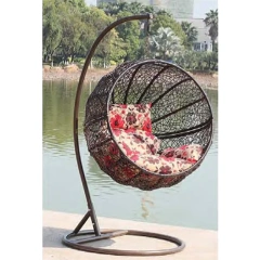 Charming Dark Rattan Swing Chair with Floral Patterned Cushion for Lakeside Relaxation,Romantic White Rattan Swing Chair with Heart-Shaped Red Cushion for Beachside Serenity