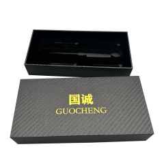 Gold logo printed on black rectangular specialty paper. Optional paper packaging for luxury gift wrapping.
