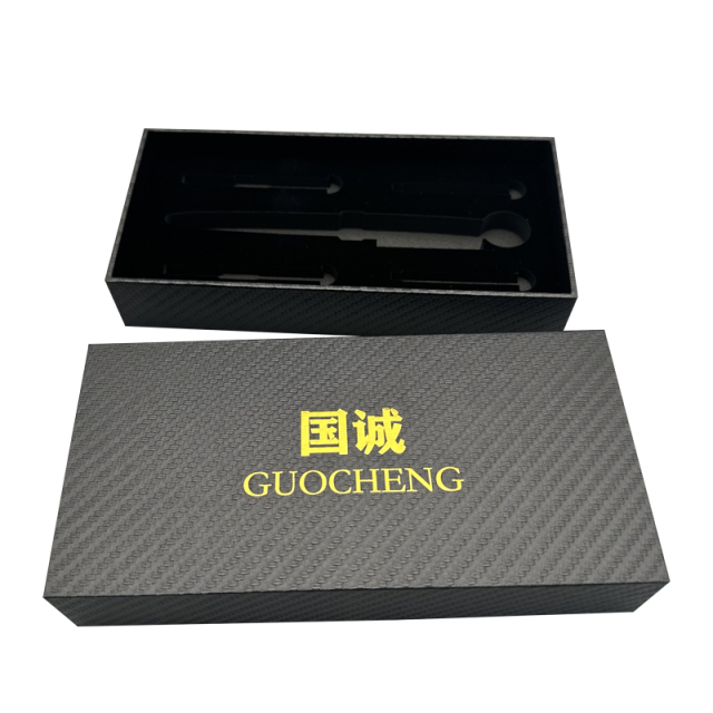 Gold logo printed on black rectangular specialty paper. Optional paper packaging for luxury gift wrapping.