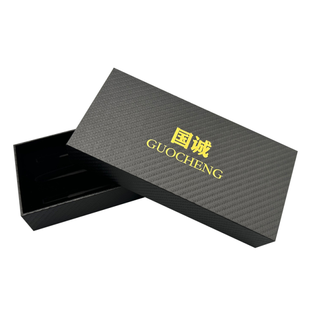 Gold logo printed on black rectangular specialty paper. Optional paper packaging for luxury gift wrapping.