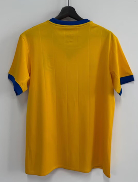 Detail view of the yellow Juventus-style retro jersey with simple clean finish and match-ready look