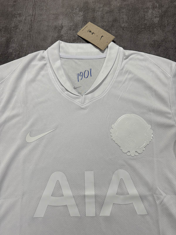 Close-up detail of the Tottenham Hotspur 125th anniversary jersey fabric, trim, and chest emblem styling