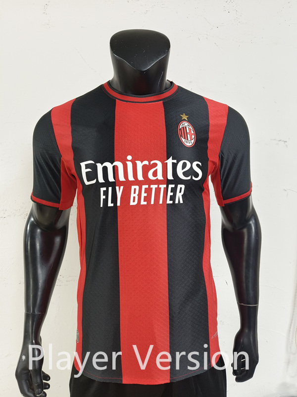 Player version AC Milan home soccer jersey in black and red, front view on a clean background