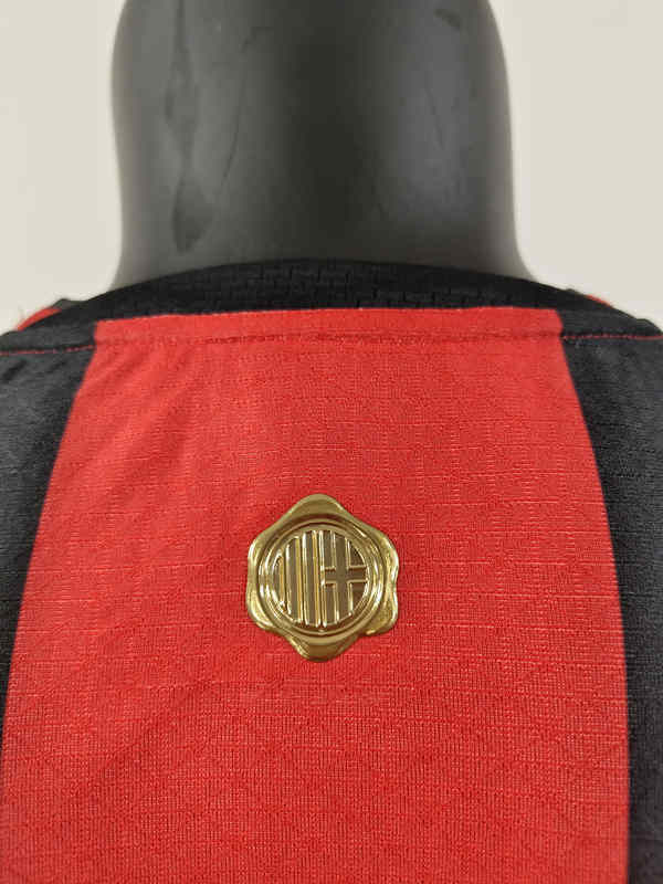 Full display of the black and red AC Milan replica jersey highlighting the front and sleeve design