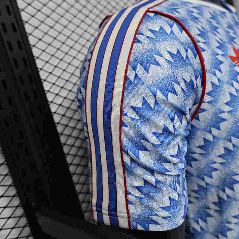 Close-up of the jersey front with player version details and retro-inspired blue pattern