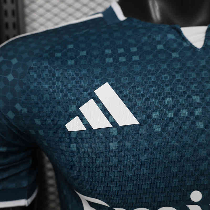 Close-up of the jersey fabric and chest area, showing the textured detailing and sharp blue design