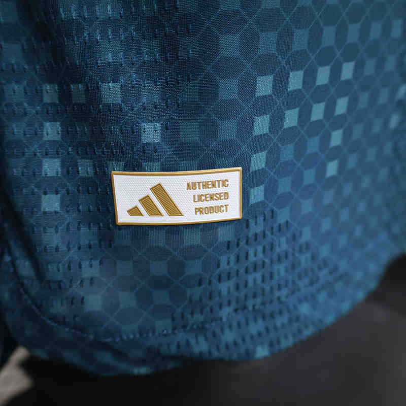 Detail shot of the jersey sleeve and shoulder area with matching blue accents and performance style