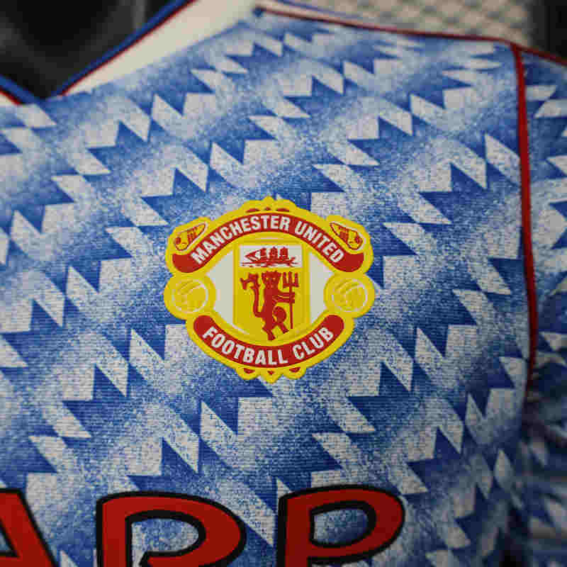 Detail shot of the jersey fabric and finishing, showing the smooth blue replica-style design