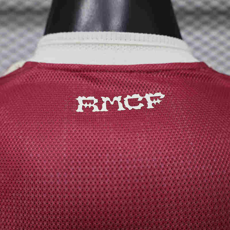 Detailed view of the sleeve and shoulder area on the red replica soccer jersey