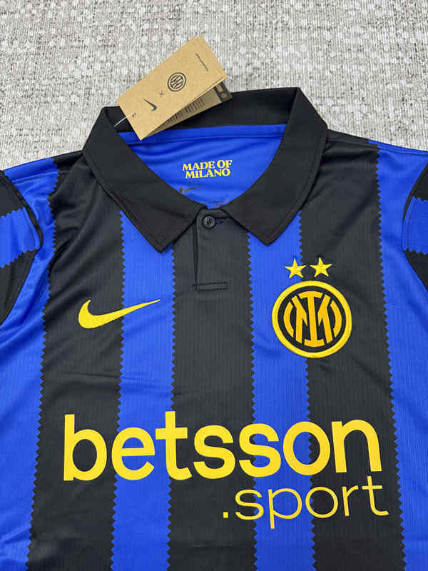 Close-up detail of the Inter Milan home jersey fabric and stripe pattern, highlighting the blue and black design with a sporty finish