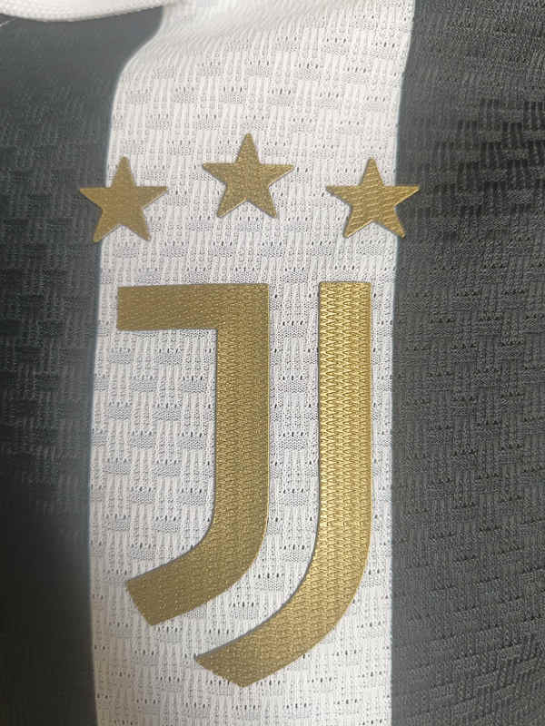 Folded display of the Juventus black and white home jersey showing the overall pattern and shirt finish