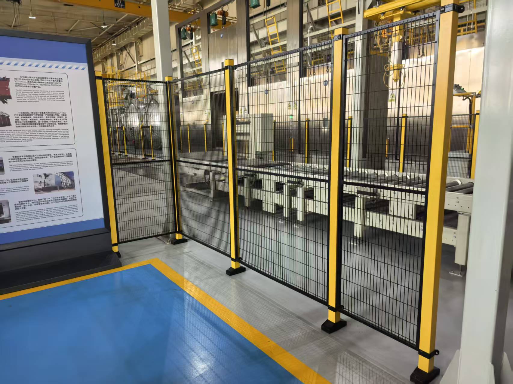Complete APAS steel mesh safety fencing system protecting industrial robot workshop