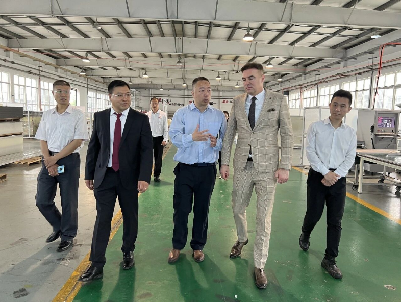 Ambassador inspecting industrial aluminum profile samples and components