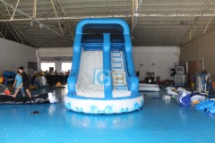Inflatable swimming pool with slide
