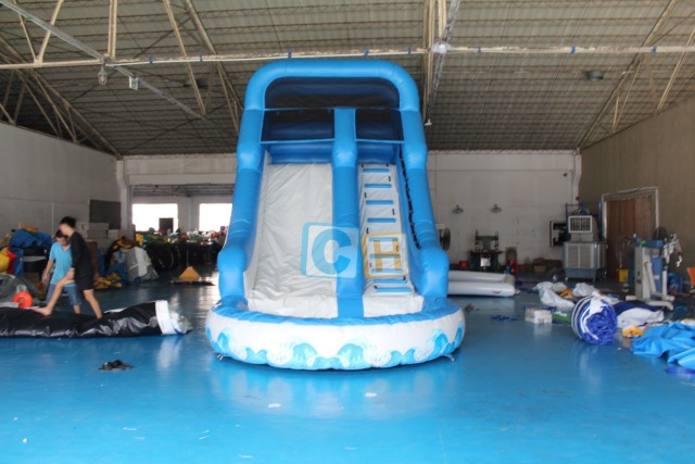 Inflatable swimming pool with slide