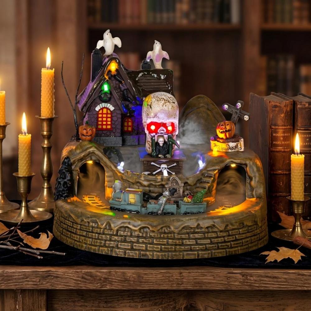 A fully lit, vibrant Halloween village diorama in a cozy, authentic home display.
