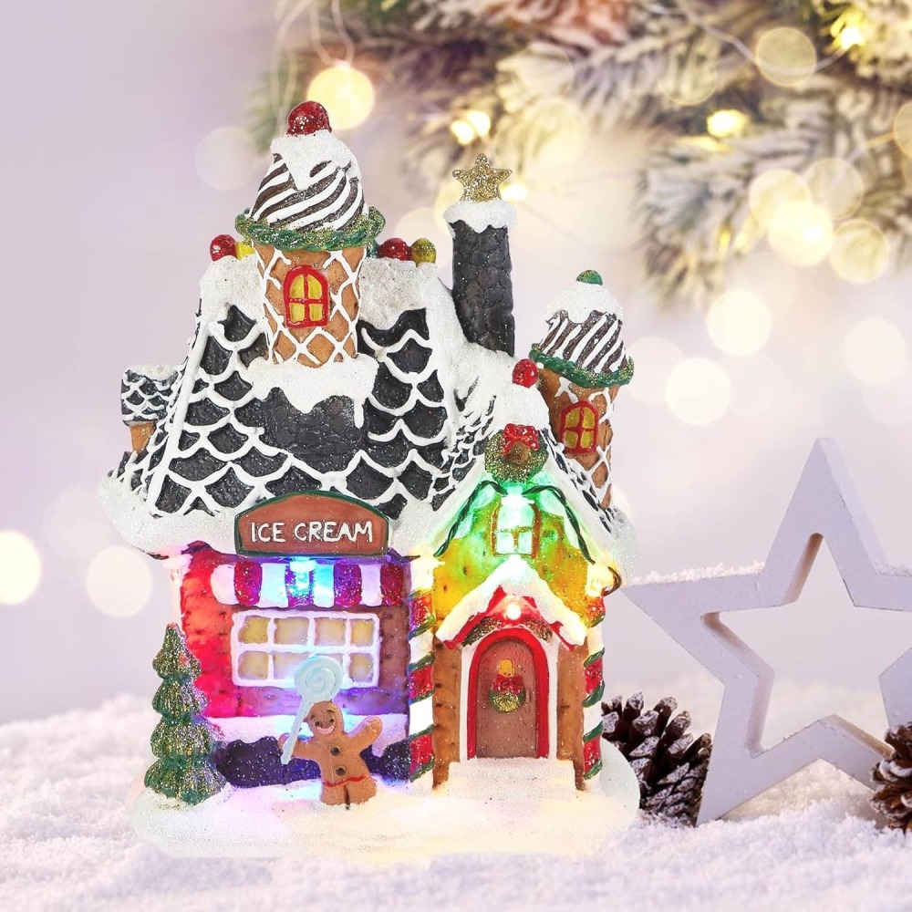 Hand-painted LED lighted Christmas Ice Cream Shop building featuring waffle-cone roofs, a gingerbread man figurine, and snow-covered details for wholesale village decor.
