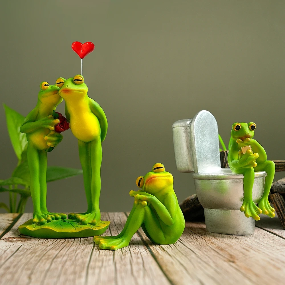 Funny resin frog figurine set featuring a romantic kissing frog couple, a meditating yoga frog, and a toilet frog using a phone for fairy garden and home décor