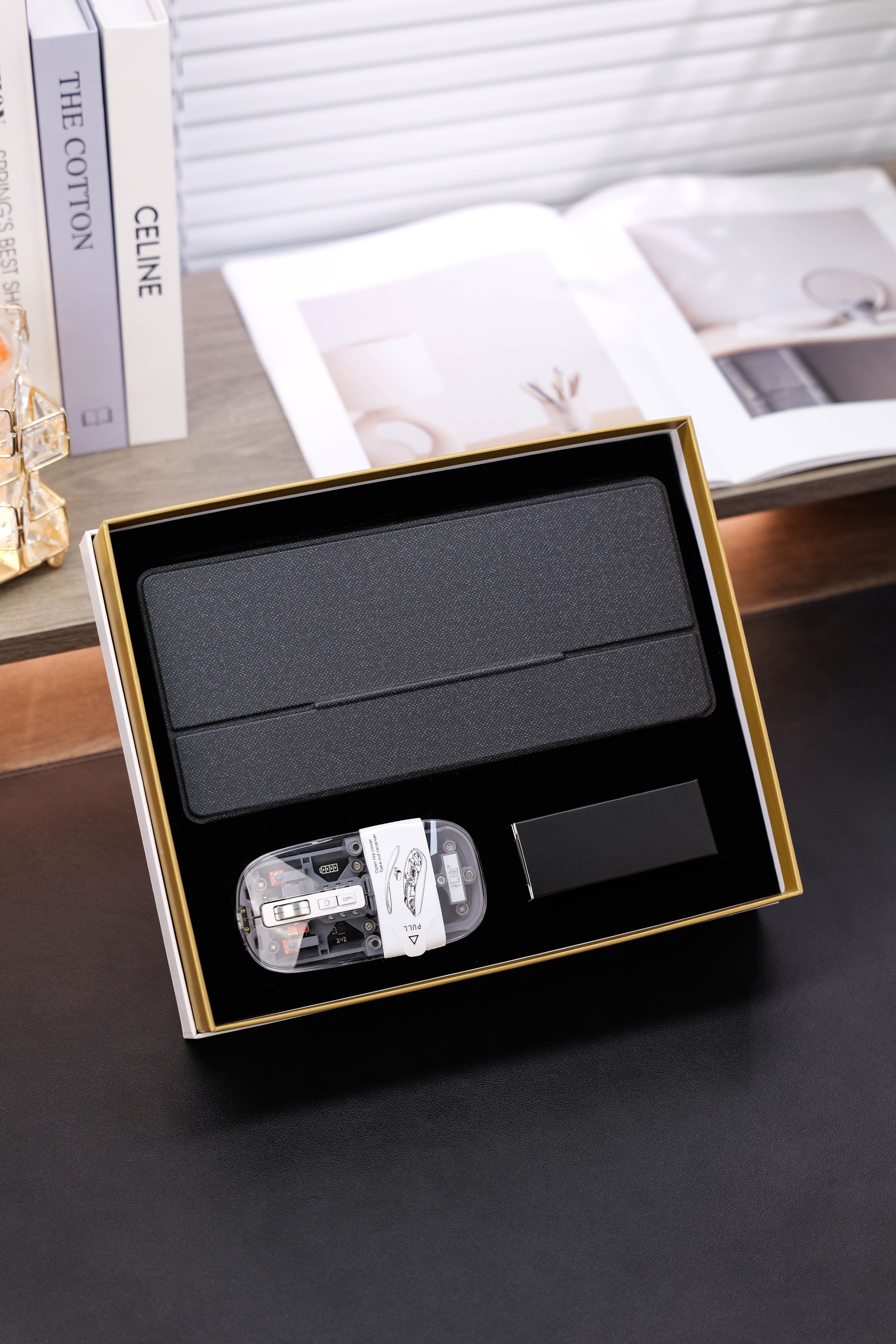 Black folding cover, transparent mouse and small black box arranged in a gift box
