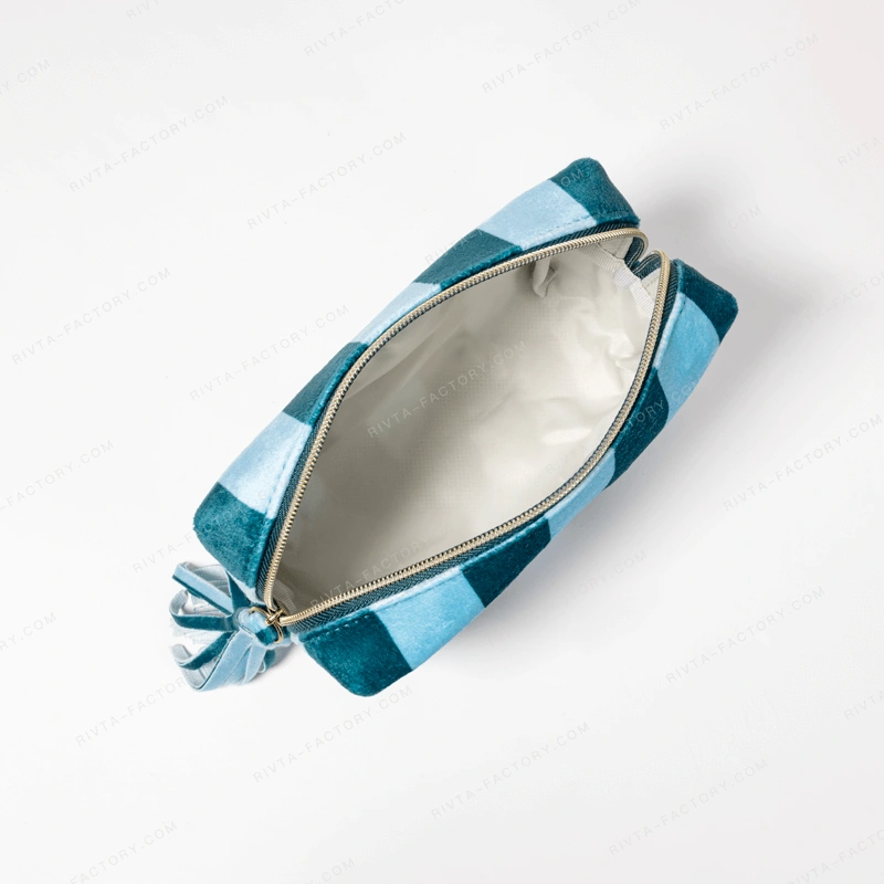 Open blue and green striped makeup pouch showing the zipper path and pale lining