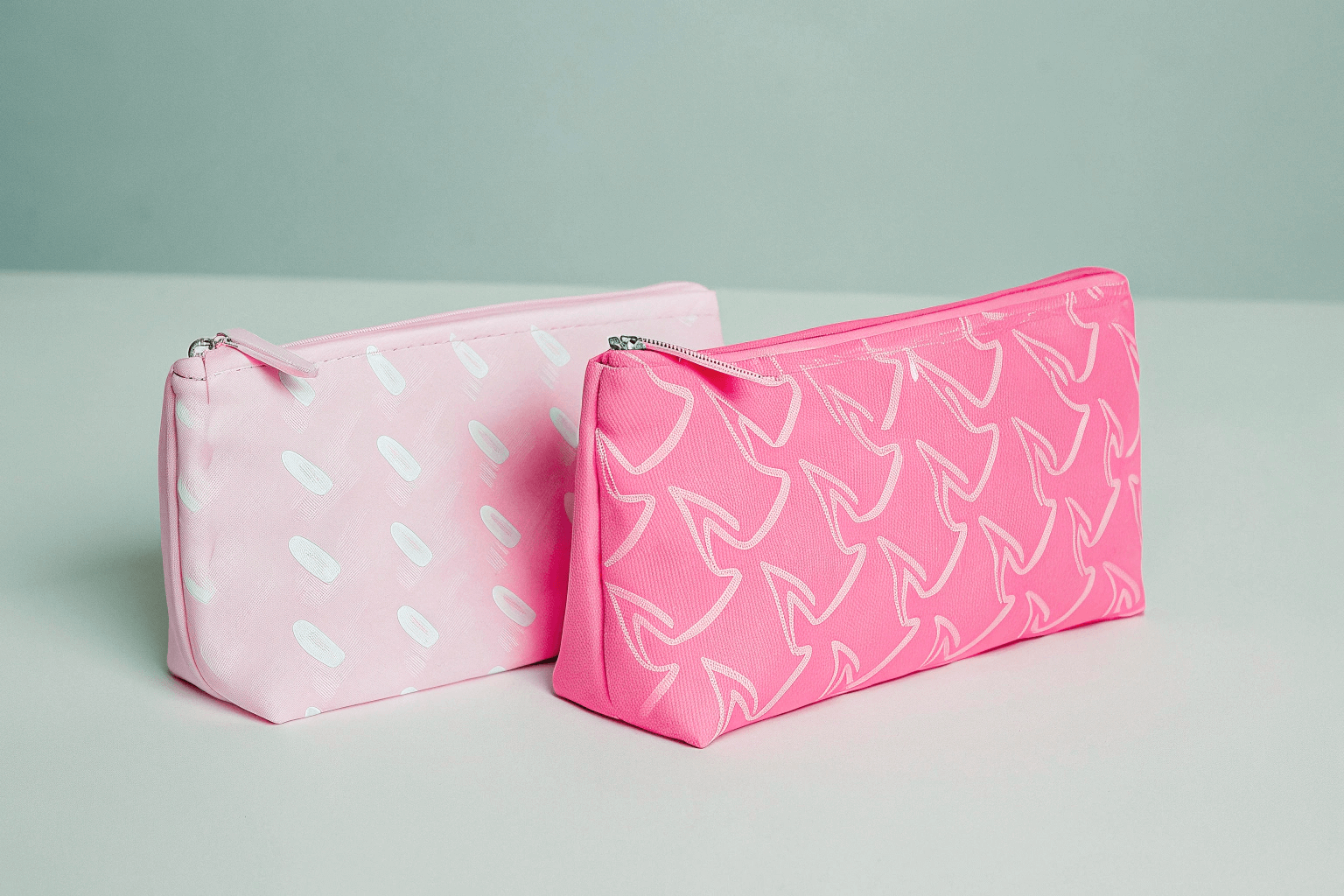 A comparison shot of cosmetic bags featuring different levels of customization, from a simple screen print to a bag with custom hardware