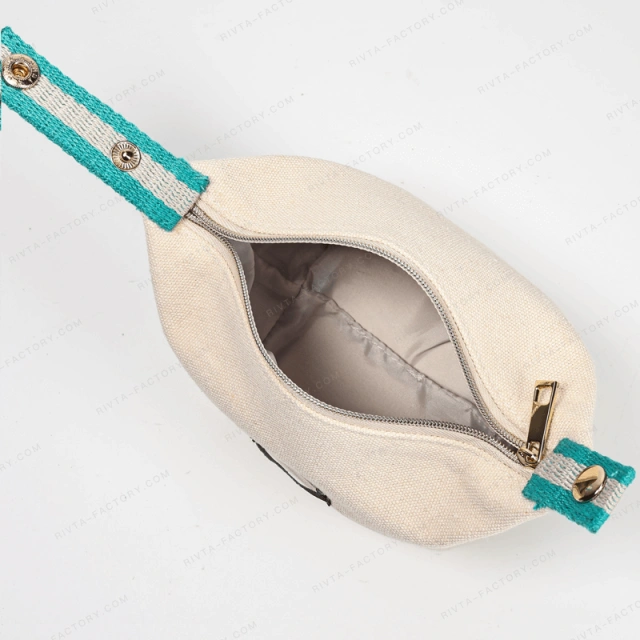 Open natural-color makeup pouch with visible lining, zipper end and green striped fabric tabs