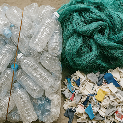 Post-consumer PET bottles are collected and sorted and cleaned