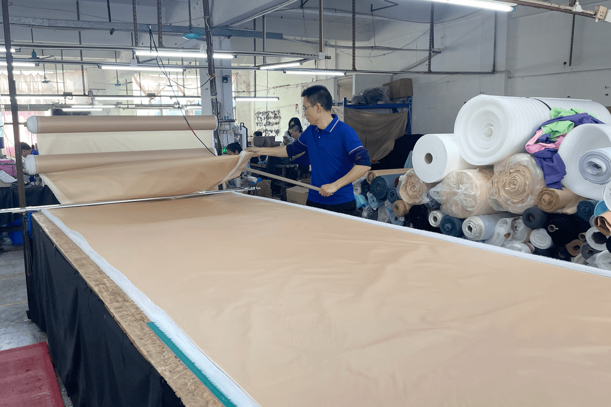 Rivta workers cutting fabric from stocked material rolls for small batch production