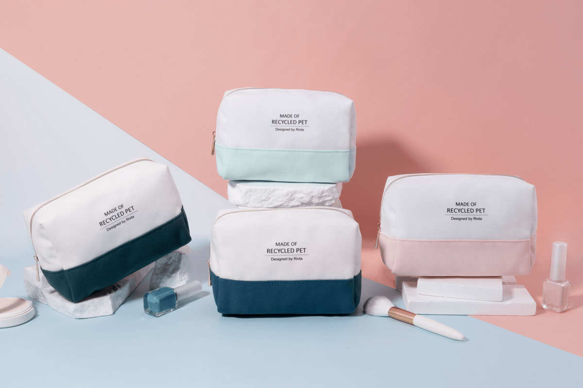 Flat lay of sustainable cosmetic bags in pastel Pantone colors with botanical elements