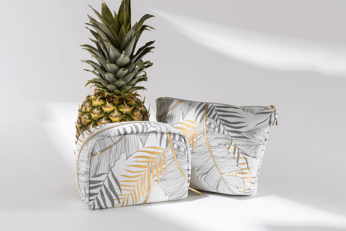 A structured cosmetic case made of pineapple fiber with a textured, crinkled surface that resembles leather.