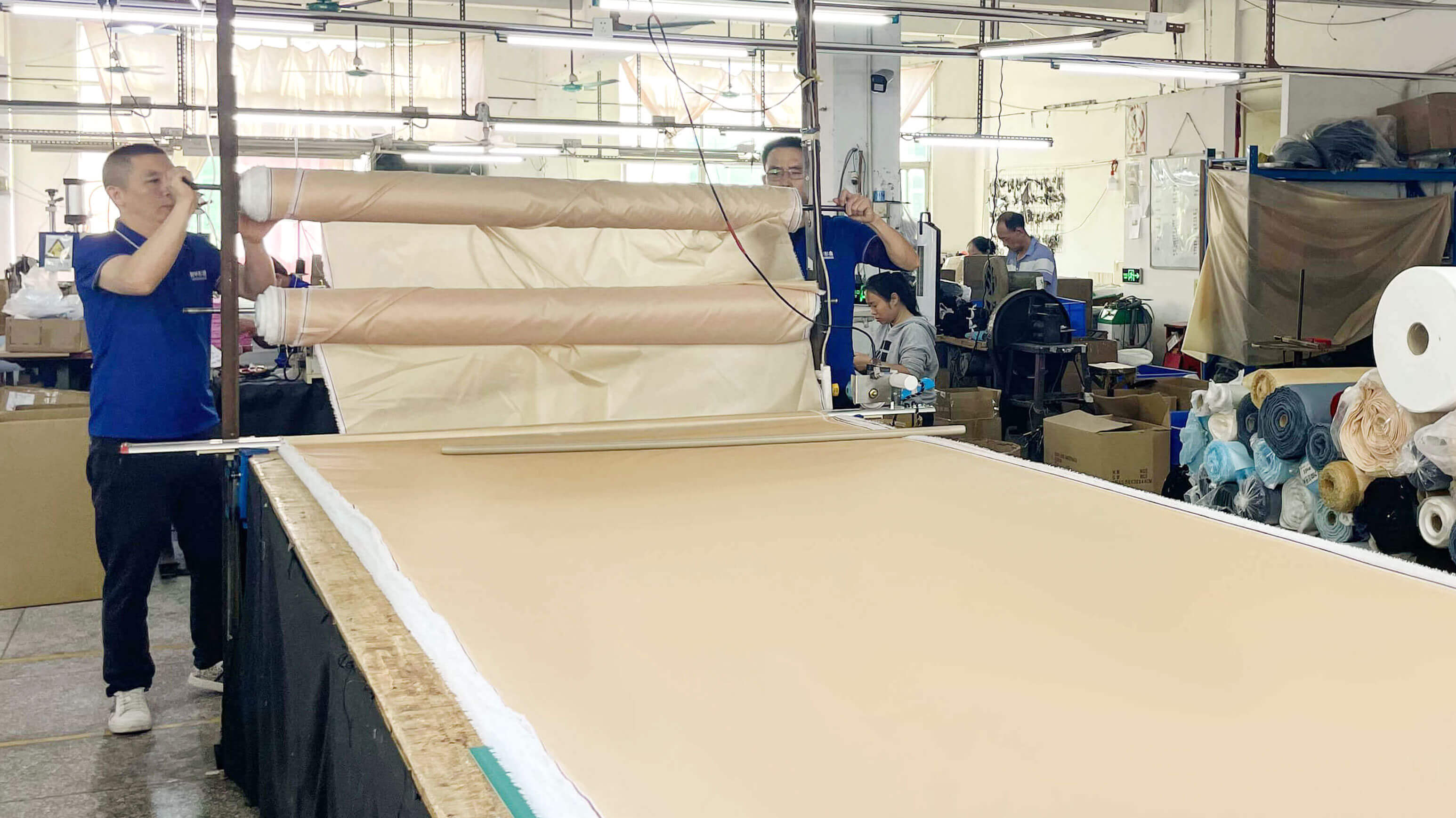 A warehouse shelf view showing rolls of colorful RPET satin fabric stock ready for production.