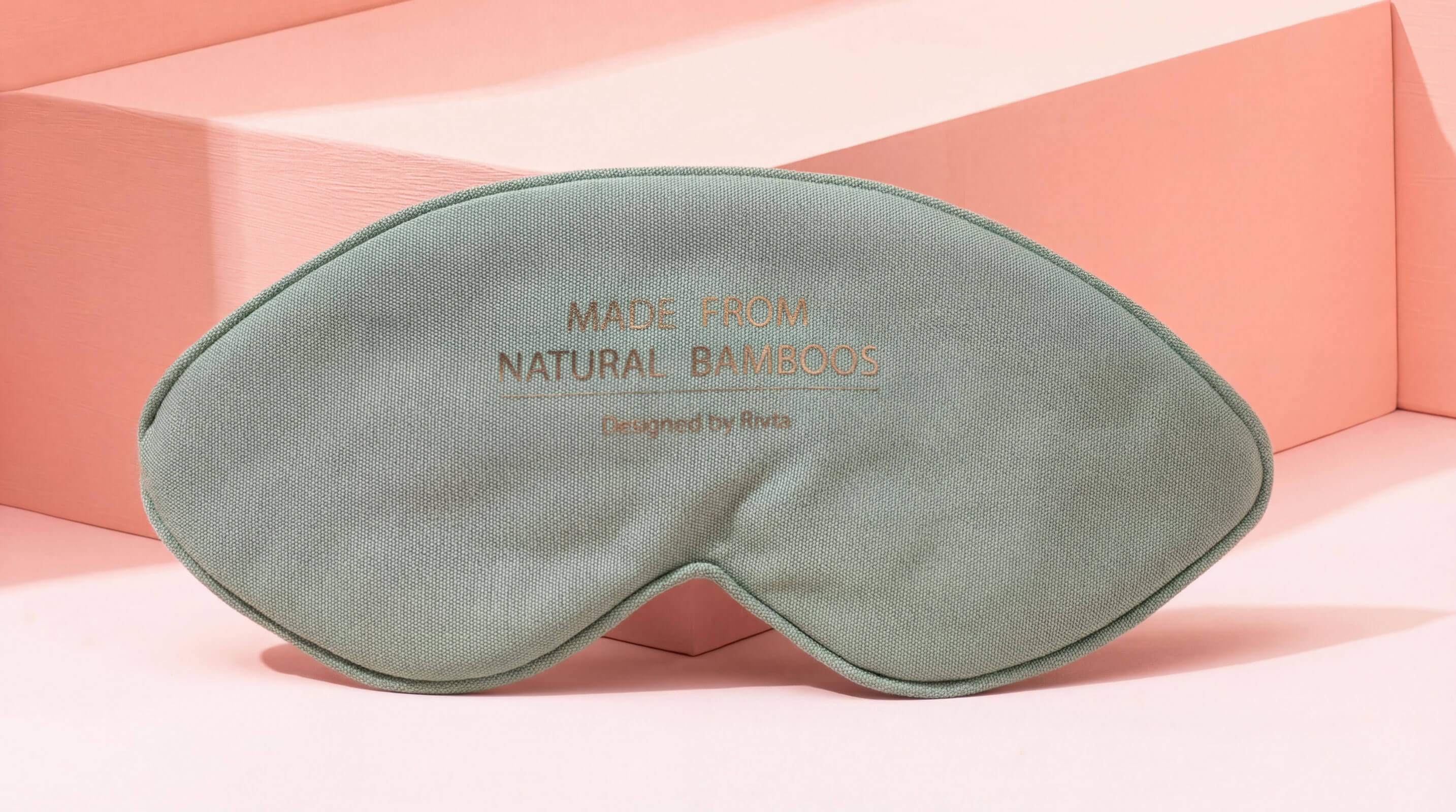 A soft, sage-green sleep mask made from organic bamboo lyocell fabric.