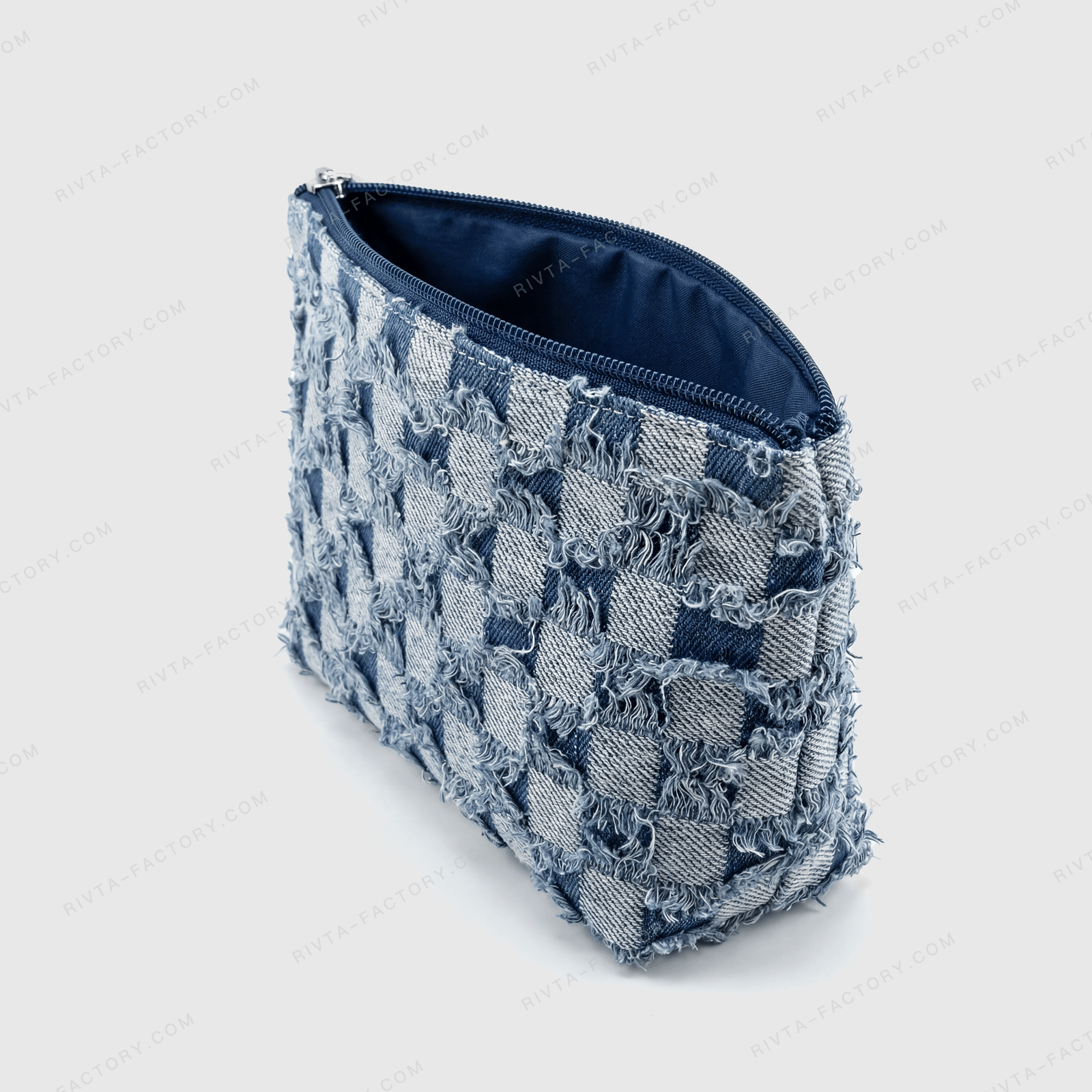 Open denim cosmetic pouch showing dark lining, zipper tape and the bag opening for assembly review