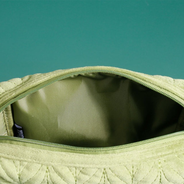 Open quilted pouch showing lining and volume for airline bulk review